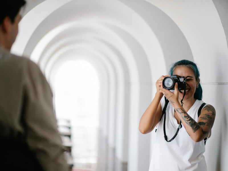Woman taking a photo of a man